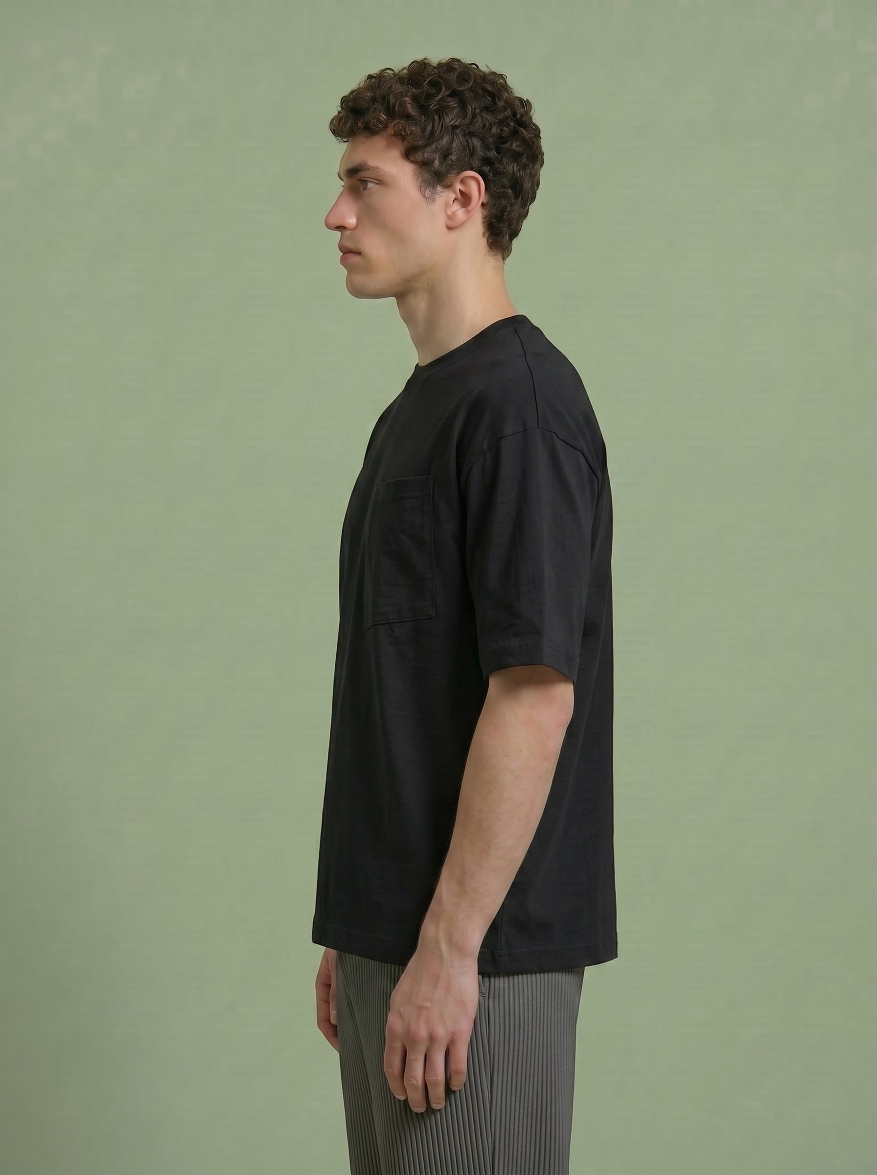 Hilos Apparel black cotton blend oversized tee with chest pocket, worn by a man.