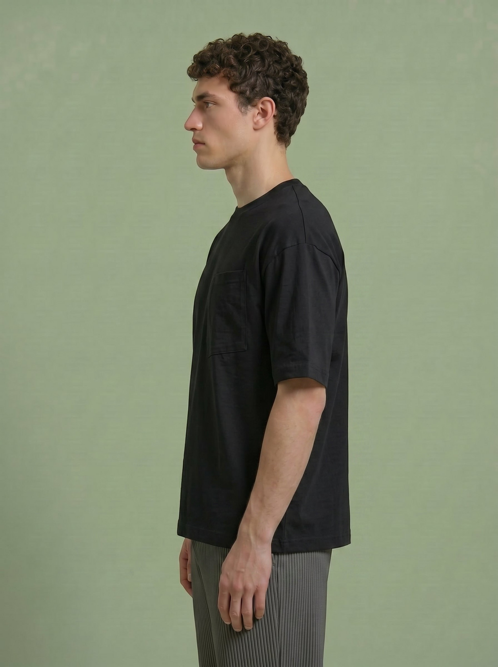 Hilos Apparel black cotton blend oversized tee with chest pocket, worn by a man.