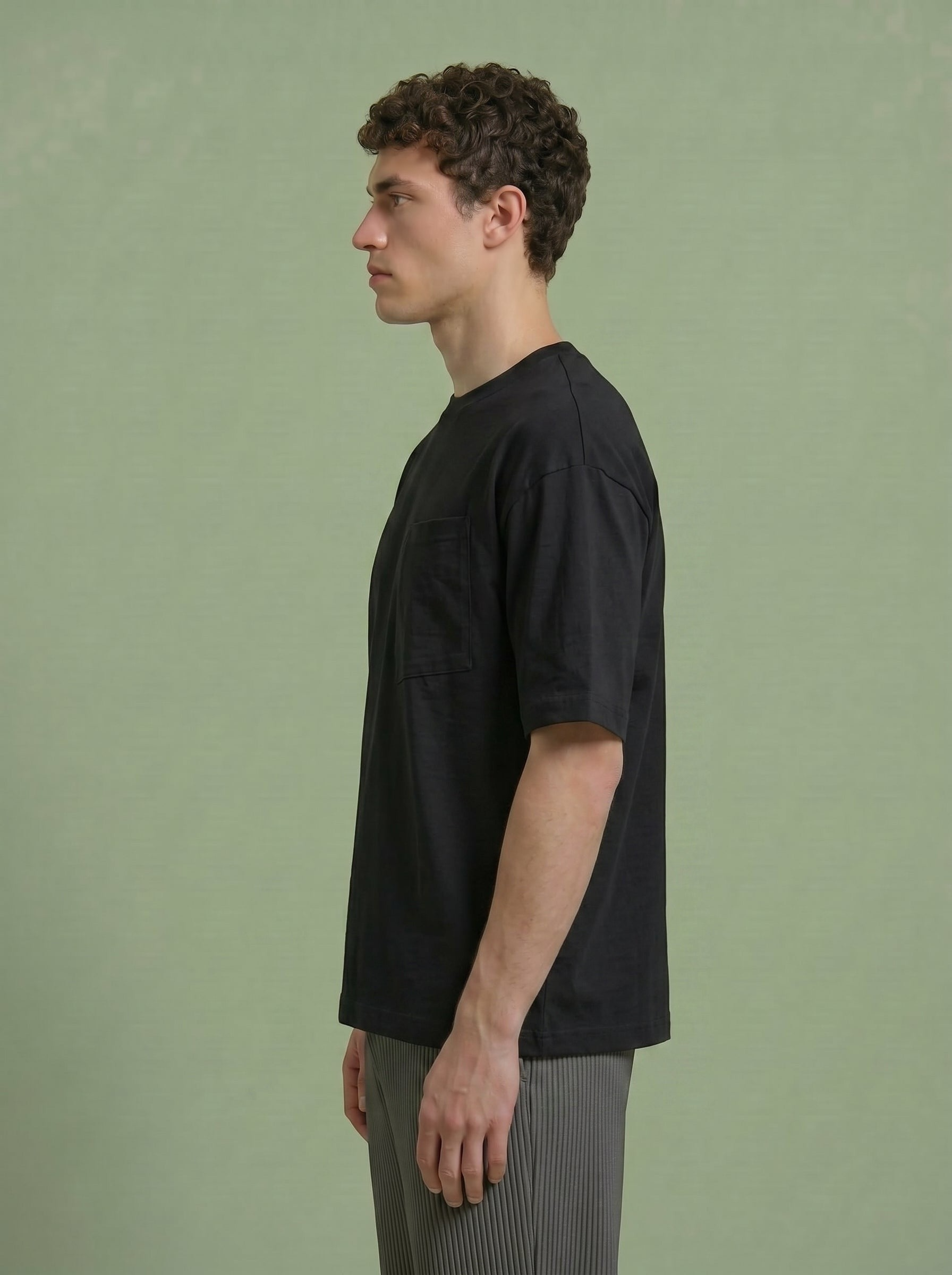 Hilos Apparel black cotton blend oversized tee with chest pocket, worn by a man.