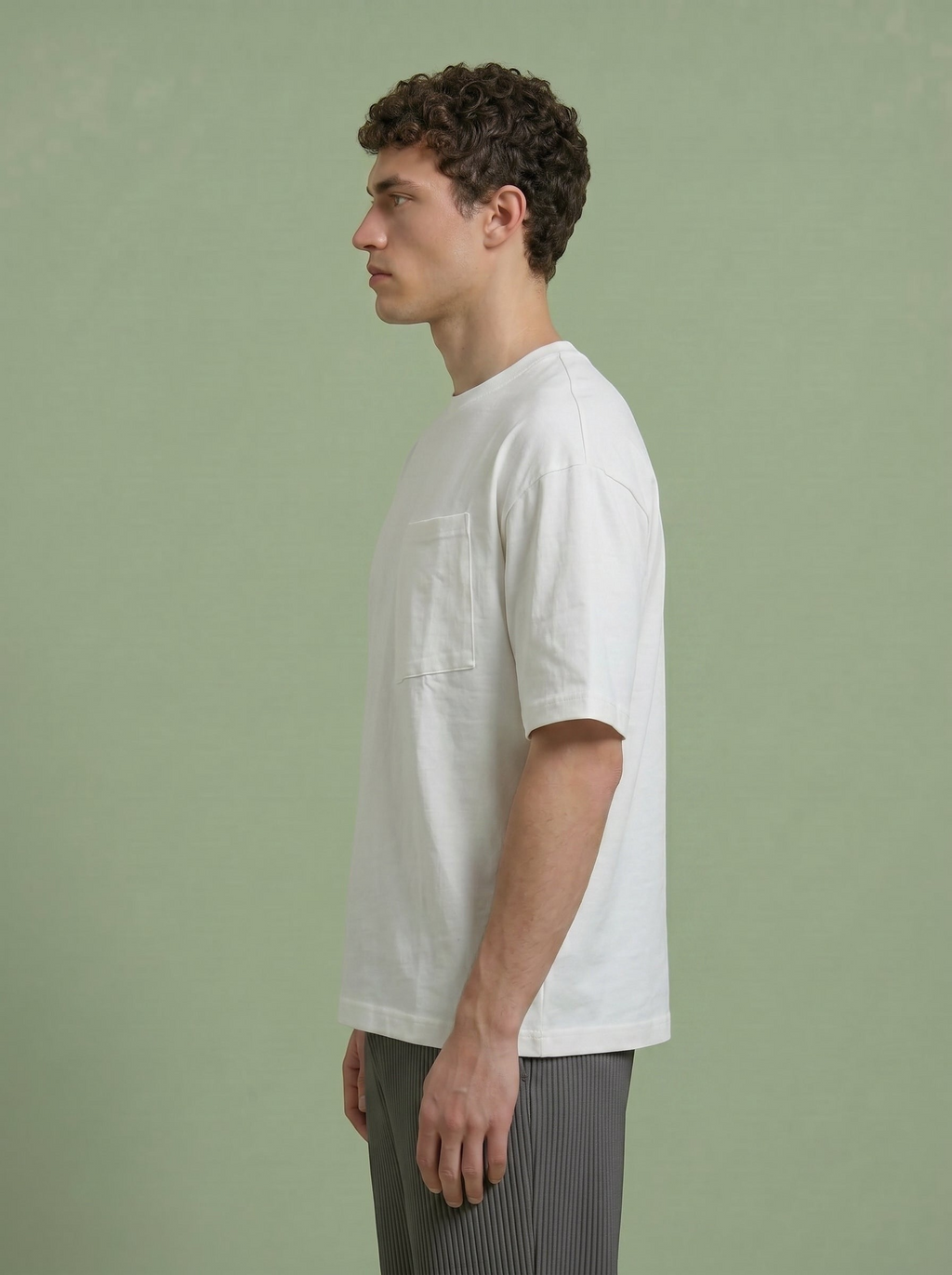 Hilos Apparel white cotton blend oversized t-shirt with chest pocket and crewneck, modelled by a man.